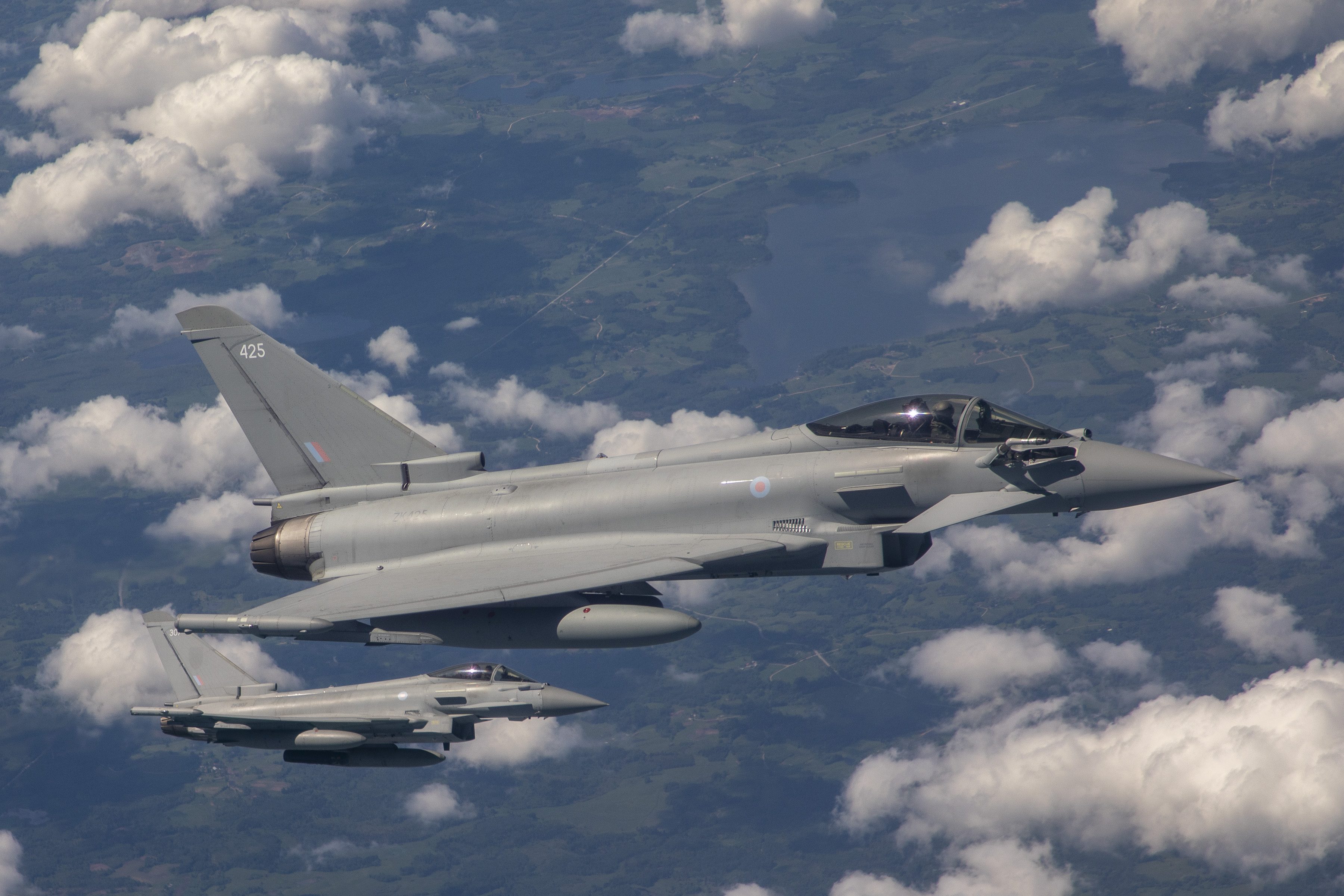 Two Typhoons in flight above the clouds.